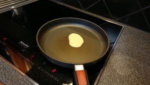 A frying pan with margarine in it.