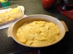 The bottom layer of the sliced potatoes.