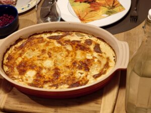 An ovenproof dish with golden coloured cream gratinated potatoes.