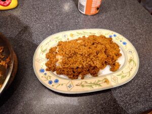 A serving plate with rice and minced meat.