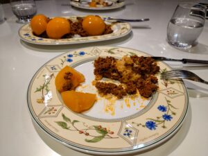 A plate with chow-chow (minced meat mix, rice, and sliced canned peaches).